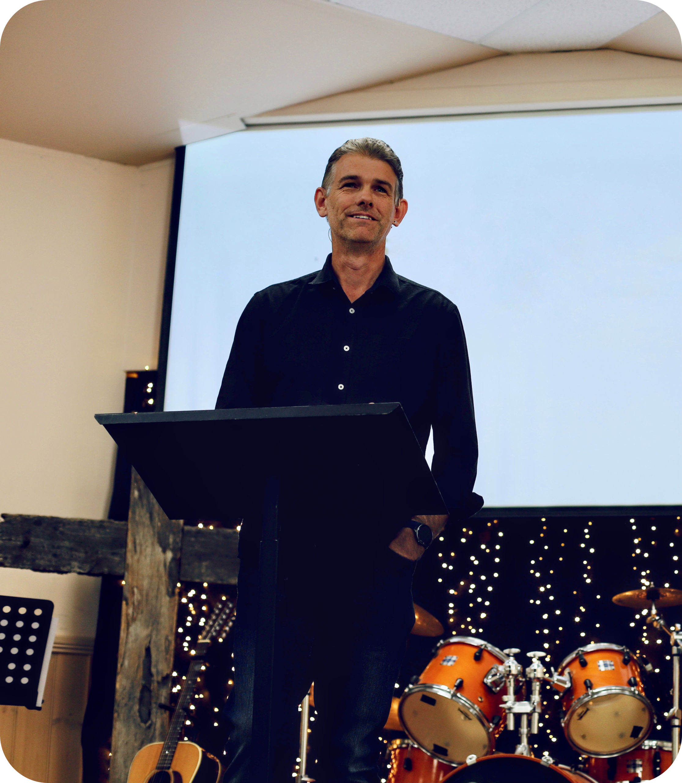 Pastor delivering a sermon, available for online viewing.